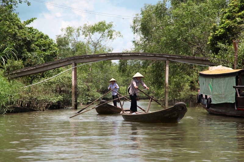 Rowing through a small canal in Mekong Delta